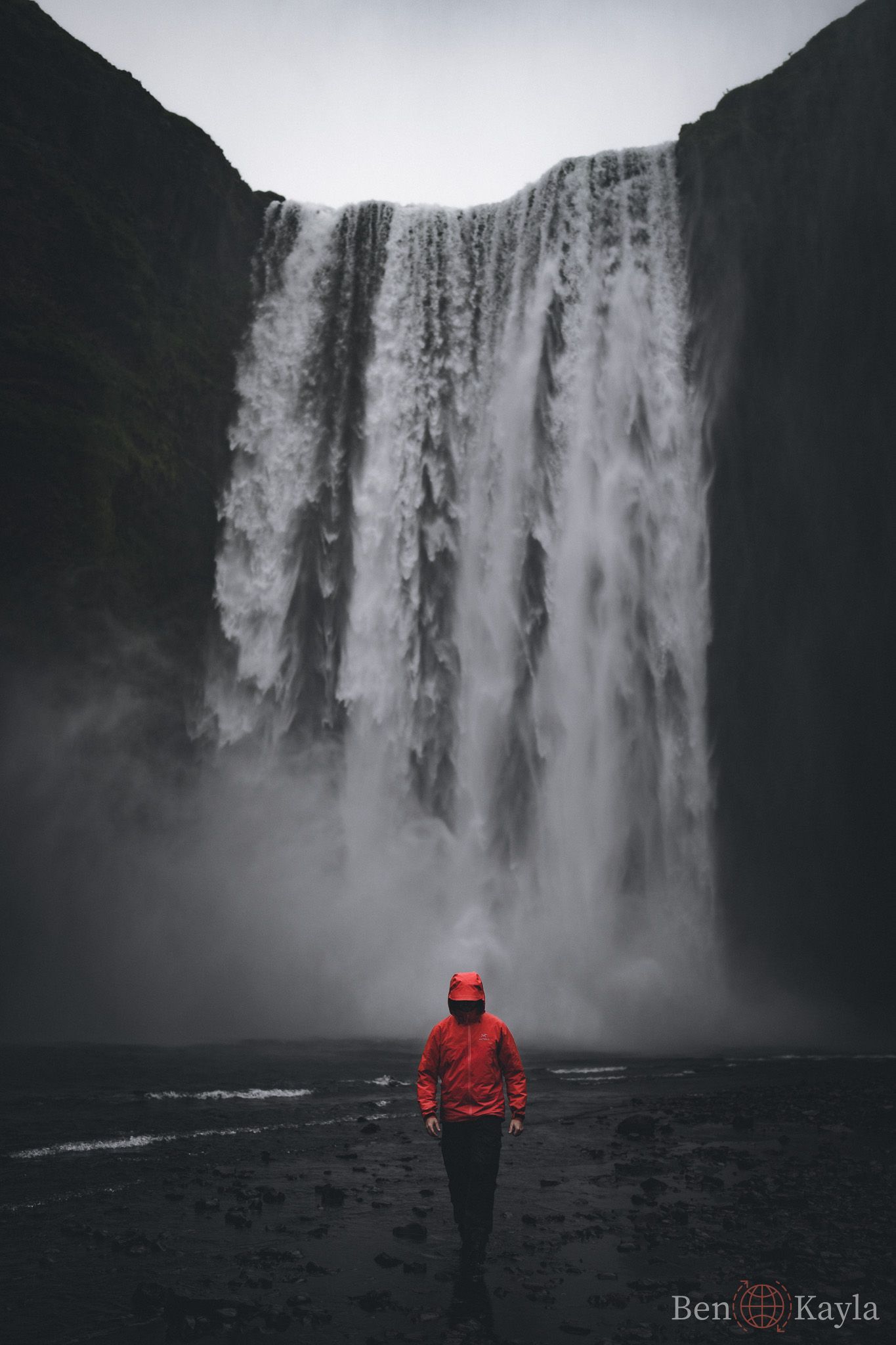 Man walking away from waterfall