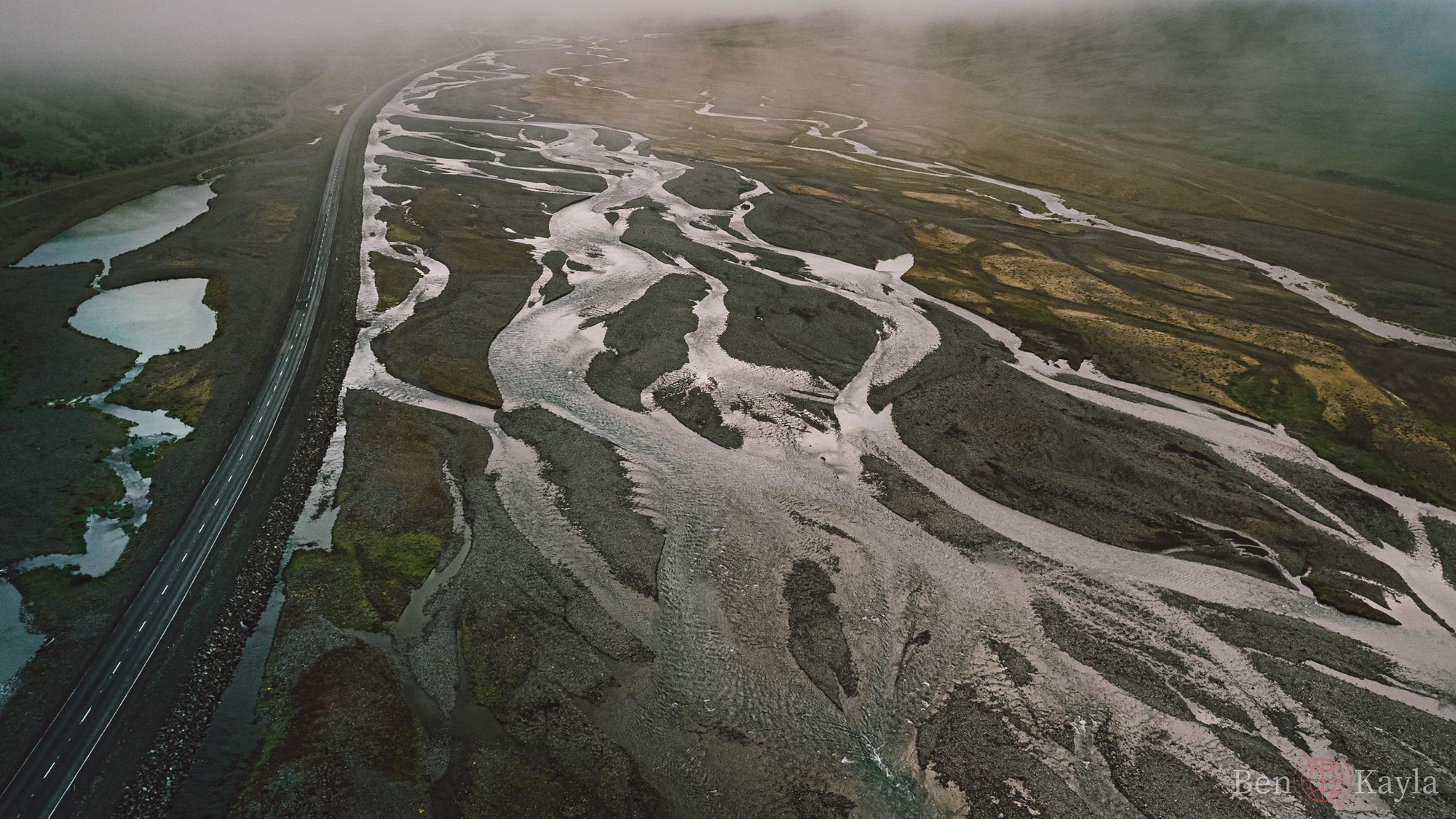 Drone shot of the river and road running through Iceland